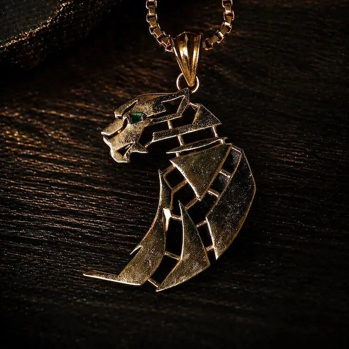 Gold panther pendant necklace on a dark wooden surface