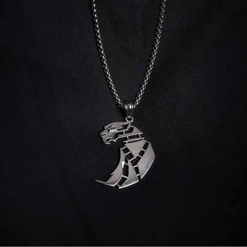 Silver panther pendant necklace on a black background