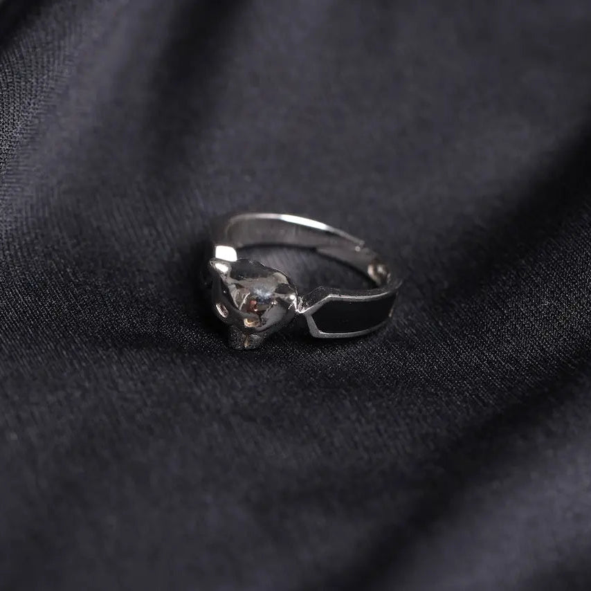 Silver ring with a gemstone on a dark fabric background